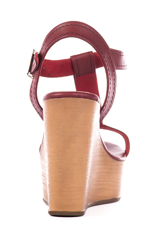 Cardinal red women's fully open sandals, with an instep strap. Round toe. Very high wedge soles. Worn view - Florence KOOIJMAN